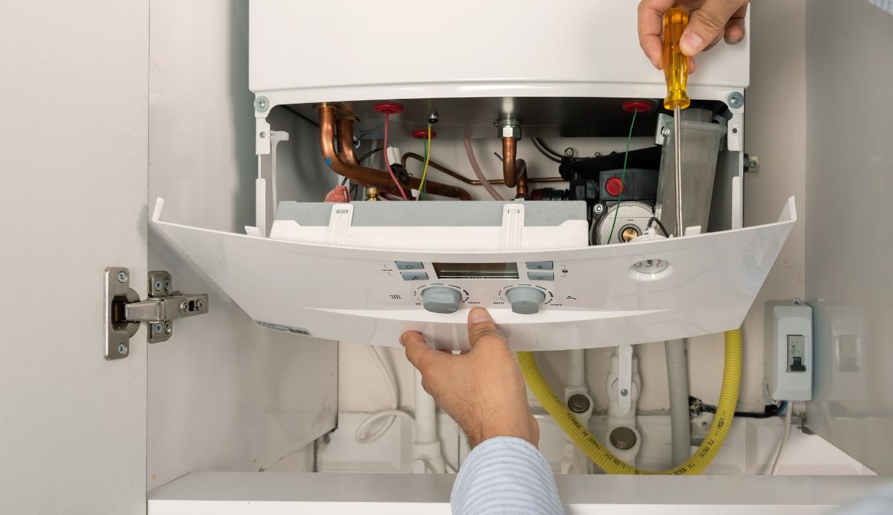 Engineer inspecting a combi boiler