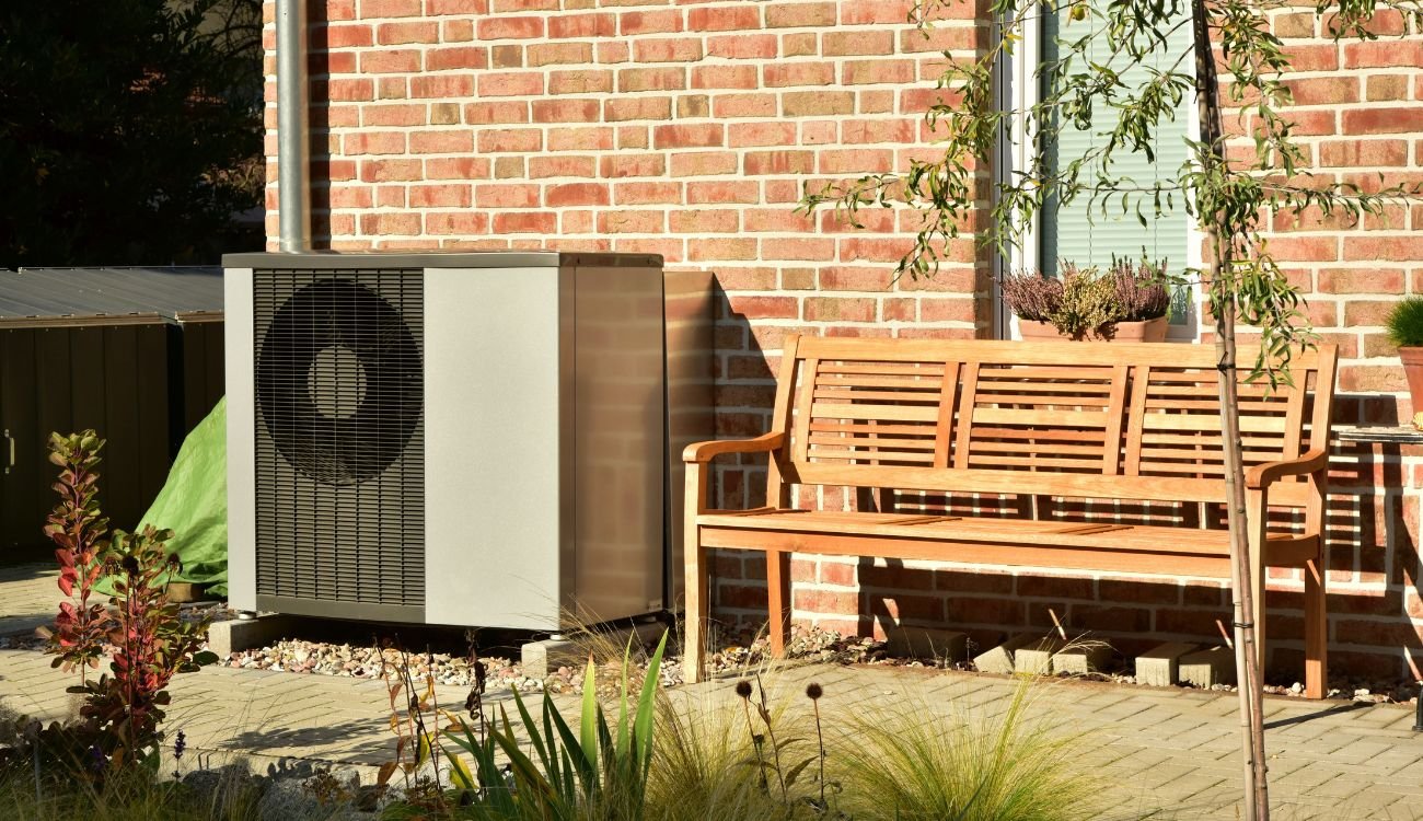 Air source heat pump installed on the outside of a house in the UK