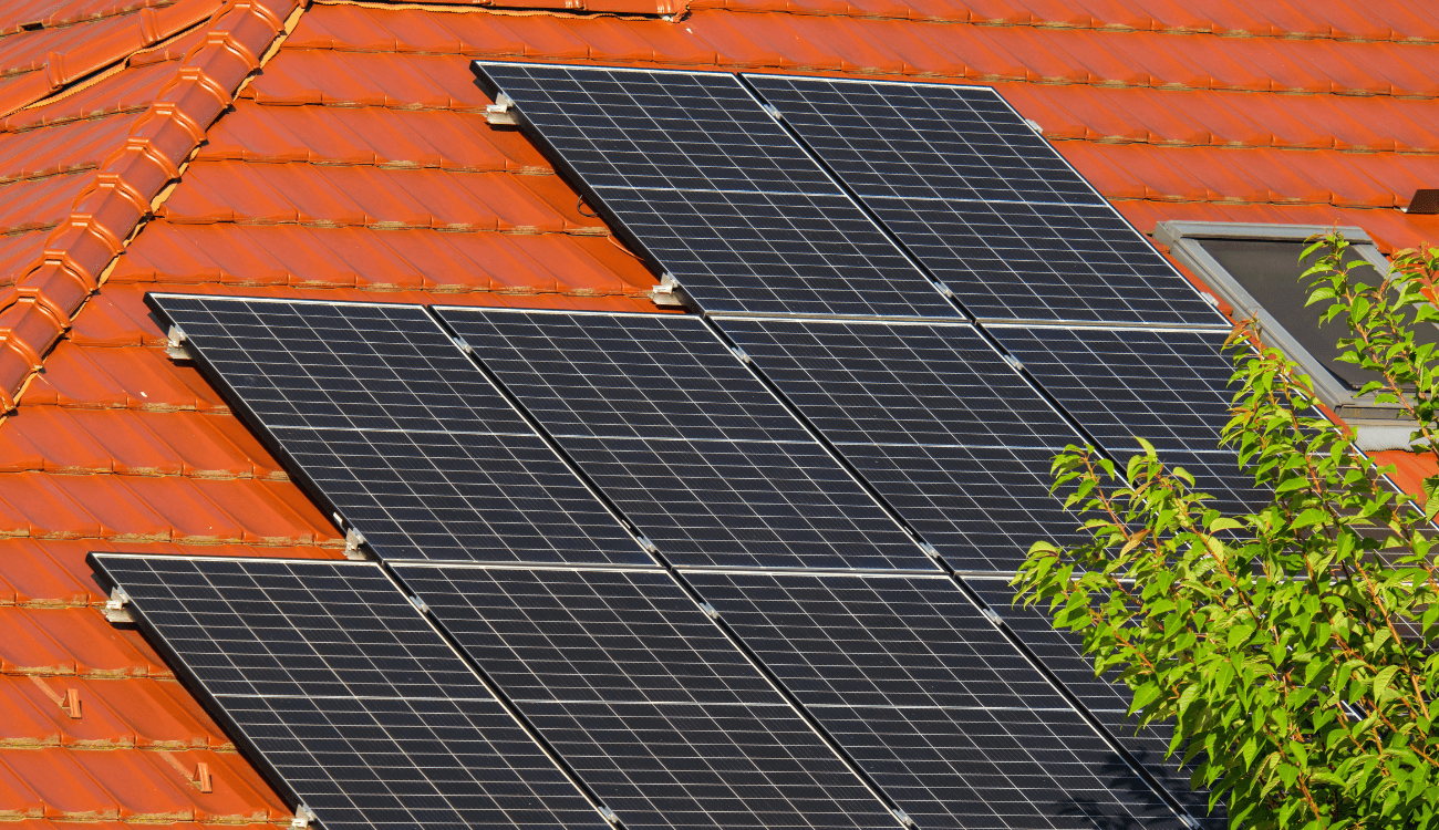 black solar panels installed tiled roof