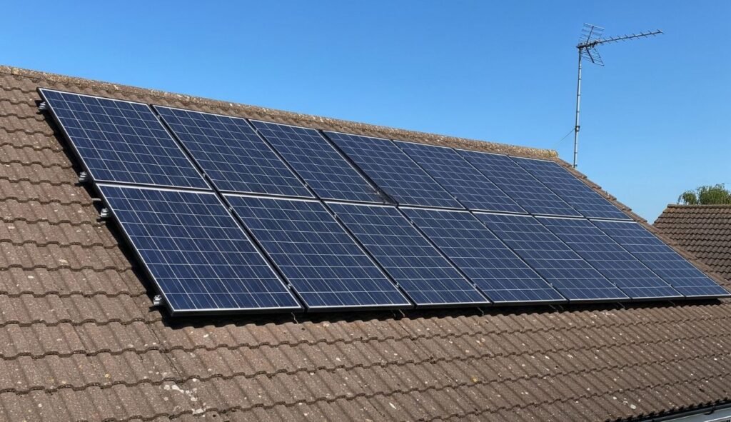 solar panels installed on the roof of a residential property in the UK with the bright blue sky in the background
